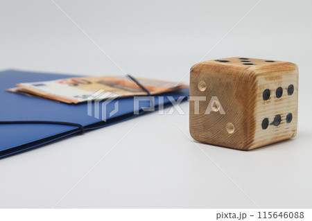 Wooden model cube on the background of banknotes. 115646088
