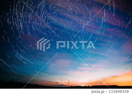 Soft Blue-orange-pink Colours. Bright Night Starry Sky. Amazing Star Trails On Night Sky Background. Trails Of Stars Above Power Line. Large Exposure. Fantasy, Illusion, Dream View 115646339