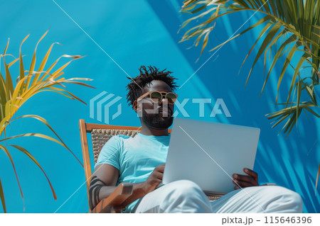 Man Using Laptop in Wicker Chair With Tropical Plants Man Using Laptop in Wicker Chair With Tropical Plants 115646396