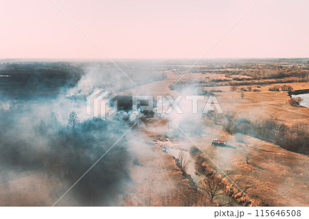 Nature In Danger. Wild Open Fire Destroys Grass. Natural Disaster. Firefighters Put Out Fire. Aerial View Of Dry Grass Burns During Drought And Hot Weather. Bush Fire And Smoke In Meadow Field 115646508