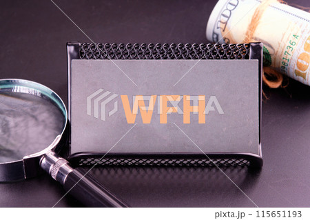 New business concept. Letters WFH, Work From Home on a gray business card in golden letters New business concept. Letters WFH, Work From Home on a gray business card in golden letters 115651193