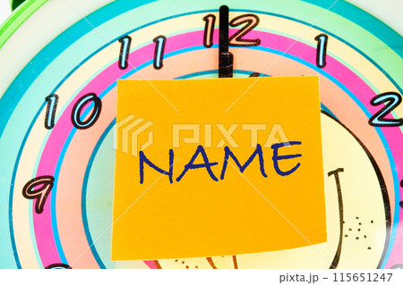 Brand and naming concept. NAME word on the sticker on the background of the watch face 115651247