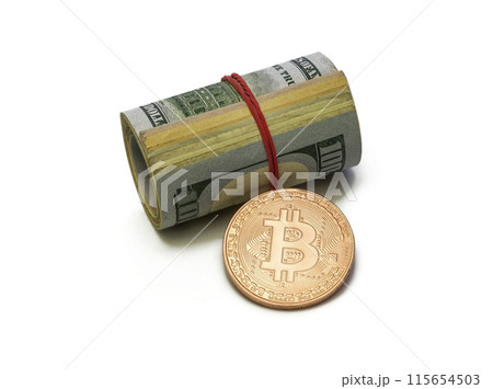 Platinum Bitcoin coin and cylinder of dollar bills on white background 115654503