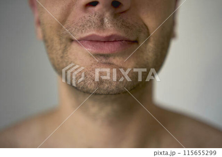 chin with bristles  of a thirty-year-old man of a  medium build 115655299