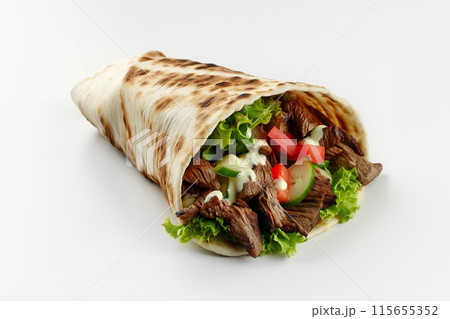 Deliciously wrapped beef shawarma with greens and a touch of creamy sauce 115655352