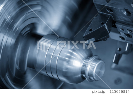 The CNC lathe machine forming cutting the metal shaft parts in the light blue scene. The CNC lathe machine forming cutting the metal shaft parts in the light blue scene. 115656814