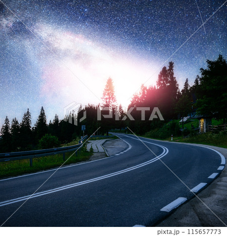 Asphalt road under a starry night sky and the Milky Way 115657773