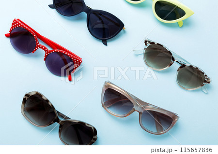 sunglasses with seashell lying on table background. Sunglasses on summer background. Top view flat lay with copy space for text sunglasses with seashell lying on table background. Sunglasses on summer background. Top view flat lay with copy space for text 115657836