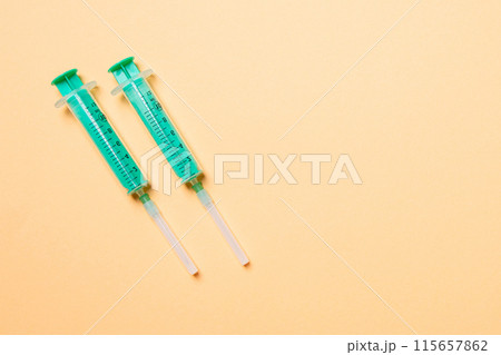 Top view of syringes in a row for medical injection on colorful background with copy space. Health and vaccination concept 115657862