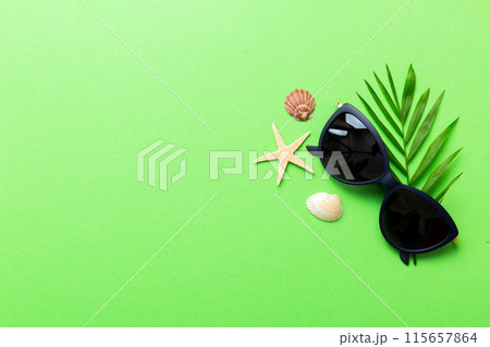sunglasses with seashell lying on table background. Sunglasses on summer background. Top view flat lay with copy space for text sunglasses with seashell lying on table background. Sunglasses on summer background. Top view flat lay with copy space for text 115657864