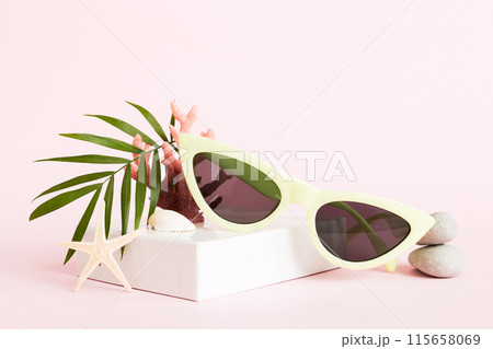 sunglasses with seashell lying on table background. Sunglasses on summer background. Top view flat lay with copy space for text sunglasses with seashell lying on table background. Sunglasses on summer background. Top view flat lay with copy space for text 115658069