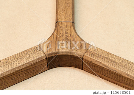 Triple jointed wooden frame of the table is made of solid oak closeup 115658501