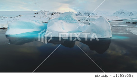 Meting ice glacier in Antarctica close up panorama. Blue water ice cave iceberg floating, reflected in ocean water. Environment ecological issue of global warming. Polar climate change at winter day. 115659588