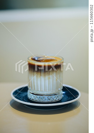 Elegant layered coffee in a clear glass, highlighting rich textures. 115660302