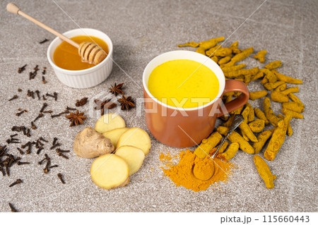 Natural Ayurvedic drink golden milk with turmeric and spices in a mug 115660443