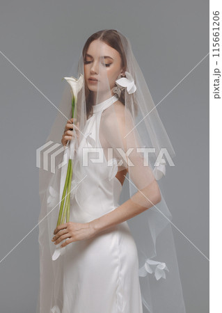 A woman in a wedding dress is holding a bouquet of flowers A woman in a wedding dress is holding a bouquet of flowers 115661206
