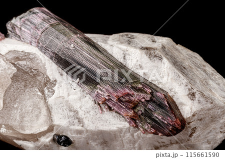 Macro stone tourmaline mineral on a black background  115661590
