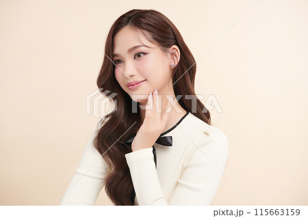 Beautiful young asian woman with clean fresh skin on beige background, Face care, Facial treatment, Cosmetology, beauty and spa, Asian women portrait. Beautiful young asian woman with clean fresh skin on beige background, Face care, Facial treatment, Cosmetology, beauty and spa, Asian women portrait. 115663159
