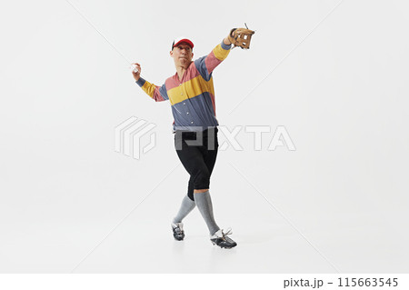 Full-length image of young guy, baseball player in serving ball, training with concentration and determination isolated on white background. 115663545