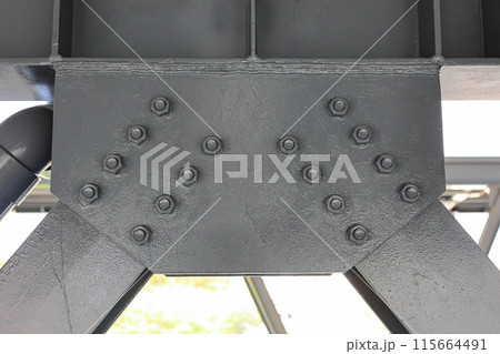 Metal supports Bolts, nuts, threaded on beams of the Steel Construction. Metal supports Bolts, nuts, threaded on beams of the Steel Construction. 115664491