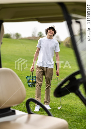 Vehicle in a golf club with young golfers inside 115665167