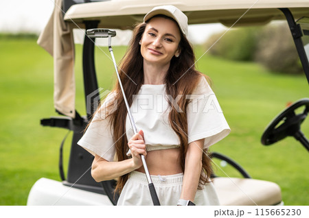 Active woman standing by the vehicle with golf in nature Active woman standing by the vehicle with golf in nature 115665230