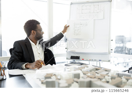 Successful man architect working on estate construction project in the office 115665246