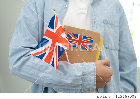 Learn English language, Asian teenage student hold book with flag in course at school. Learn English language, Asian teenage student hold book with flag in course at school. 115665988