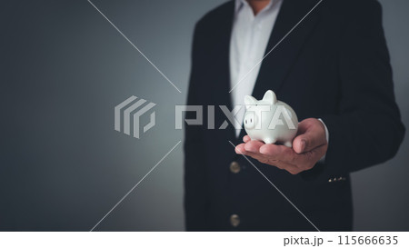 Money saving concept, Businessman holding the white piggy bank for saving money concept, Save for investment, banking, loan, home loan, Financial planning, education and healthy insurance. Money saving concept, Businessman holding the white piggy bank for saving money concept, Save for investment, banking, loan, home loan, Financial planning, education and healthy insurance. 115666635