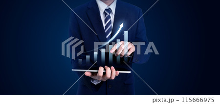 Businessman in a suit using a tablet with a digital bar chart showing growth. Concepts of business, finance, investment, profit, and development in a corporate setting 115666975