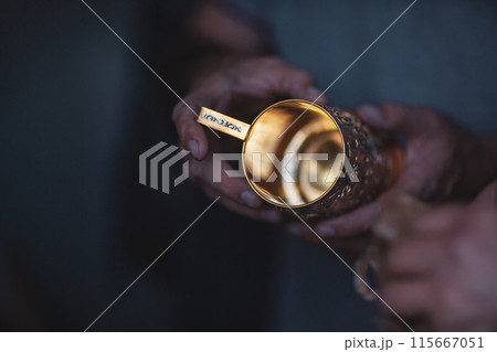 Hands of a jewelry maker at work, close-up. Golden cup holder 115667051