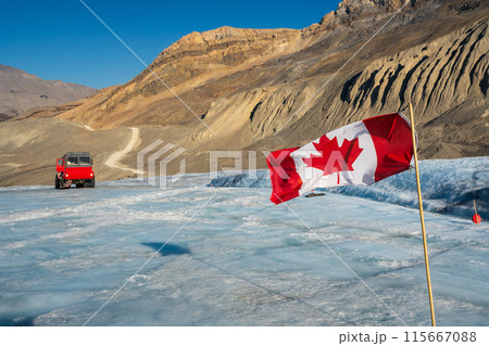 Canadian flag and Ice explorer vehicle on Athabasca glacier of Columbia Icefield, Jasper National Park, Alberta, Canada. Canadian flag and Ice explorer vehicle on Athabasca glacier of Columbia Icefield, Jasper National Park, Alberta, Canada. 115667088