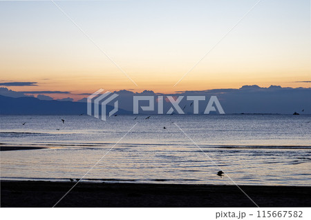 Sunset serenity on a tranquil Mediterranean beach 115667582