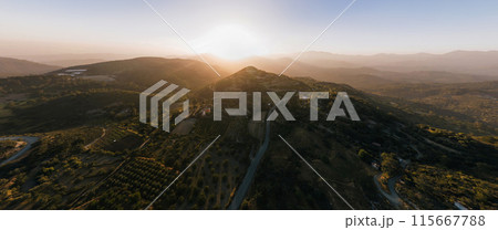 Sun setting behind mountain overlooking Prastio village. Limassol District, Cyprus Sun setting behind mountain overlooking Prastio village. Limassol District, Cyprus 115667788