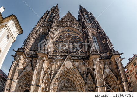 Wide-angle view of a Saint Vitus gothic cathedral's exterior with intricate details. Prague, Czech Republic Wide-angle view of a Saint Vitus gothic cathedral's exterior with intricate details. Prague, Czech Republic 115667789