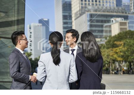 group of asian business people standing chatting on street in downtown group of asian business people standing chatting on street in downtown 115668132