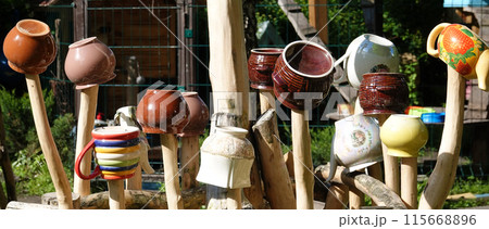 Kyiv, Ukraine April 29, 2024: Ancient Ukrainian fence with old dishes placed on top of the fence 115668896