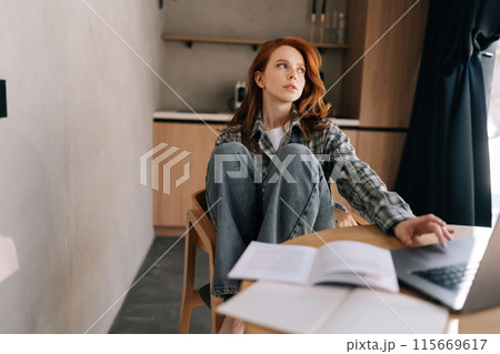 Portrait of pensive young woman working or learning online on laptop looking away thinking of solution sitting at home desk using computer, planning project, considering new ideas, remote work. Portrait of pensive young woman working or learning online on laptop looking away thinking of solution sitting at home desk using computer, planning project, considering new ideas, remote work. 115669617