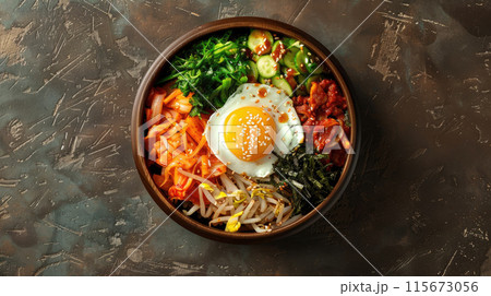 A bowl of food with a fried egg and vegetables 115673056