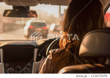 A woman is driving a car on a busy street 115673076