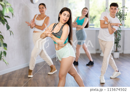 Hispanic teenage girl practicing energetic dance in choreography class 115674502