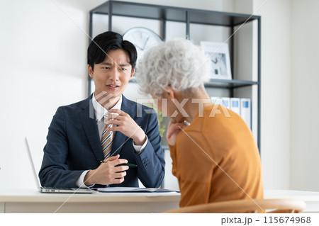 シニアの女性の悩みに対応するビジネスマン　 115674968