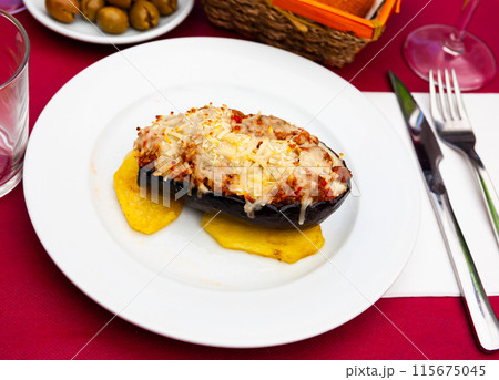Image of a stuffed eggplant with cheese baked on top 115675045