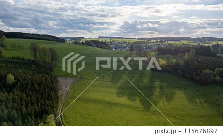 Aerial View of Verdant Fields and Small Village in Hautes Fagnes, Belgium Aerial View of Verdant Fields and Small Village in Hautes Fagnes, Belgium 115676897