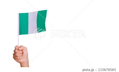 Wind waving a nigerian pennant holding by a hand Wind waving a nigerian pennant holding by a hand 115678565
