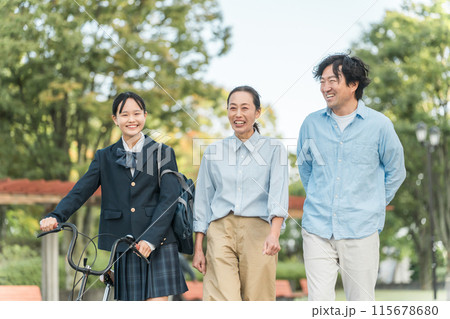 公園を歩く中学生・高校生と両親の家族・ファミリー(送り迎え・娘・両親・3人) 公園を歩く中学生・高校生と両親の家族・ファミリー(送り迎え・娘・両親・3人) 115678680
