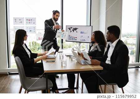 Business team discussing financial report in meeting room Business team discussing financial report in meeting room 115679952