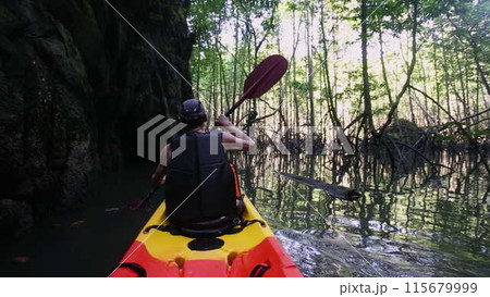 Man passes route for advanced kayakers paddling near cliff Man passes route for advanced kayakers paddling near cliff 115679999