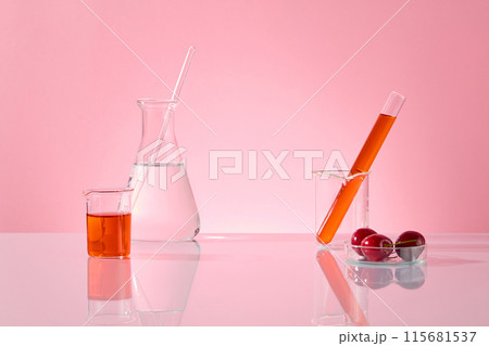 Laboratory concept photo with cherry ingredient, some lab items displayed on white countertop against pink background. Blank space for designing and adding text, front view 115681537