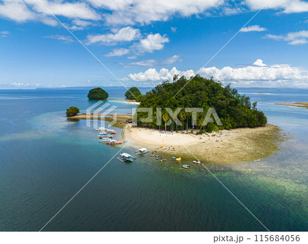 Hiyor-Hiyoran Island with white sand beach and boats. Britania Group of Islands. Surigao del Sur, Philippines. Hiyor-Hiyoran Island with white sand beach and boats. Britania Group of Islands. Surigao del Sur, Philippines. 115684056